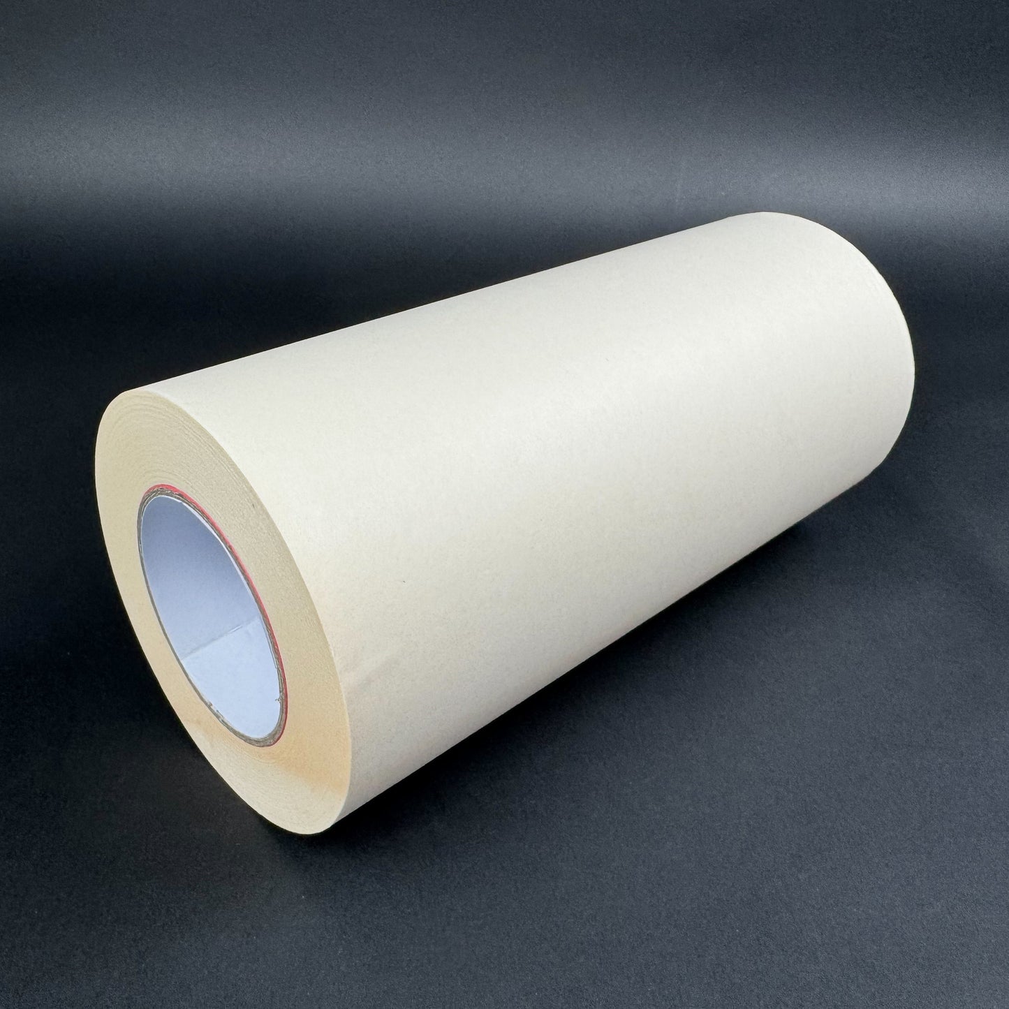Roll of white carrier tape paper on a dark gray background