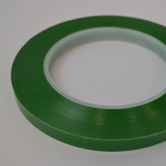 Roll of green tape on a white background