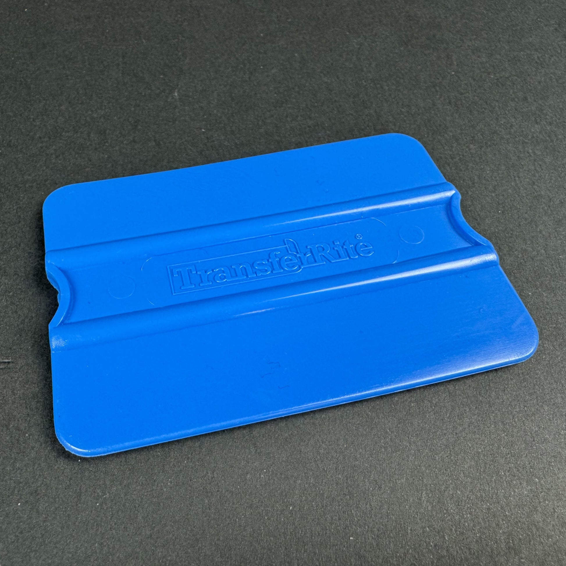 Blue squeegee on a gray background